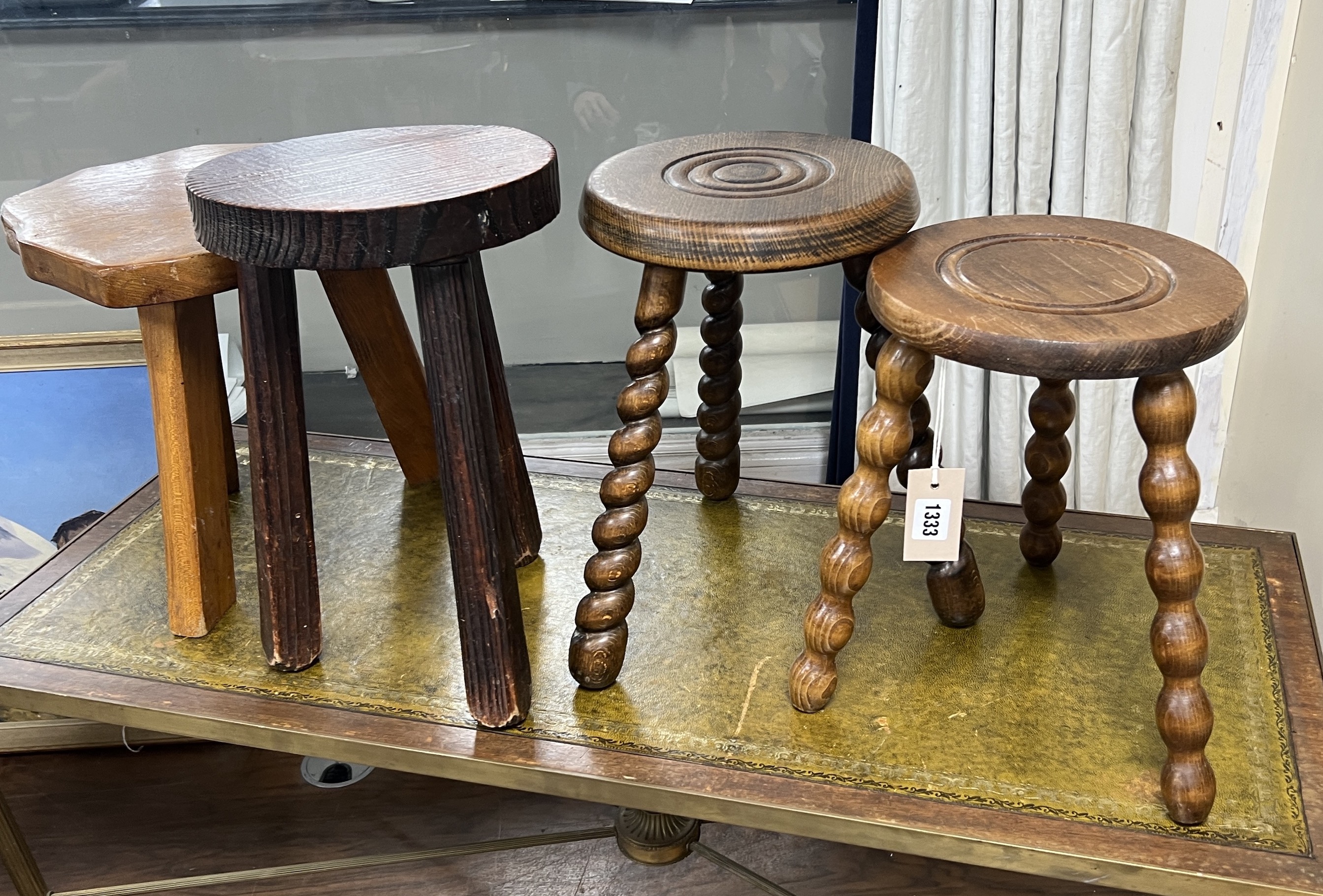 Four assorted French milking stools, largest width 24cm, height 39cm